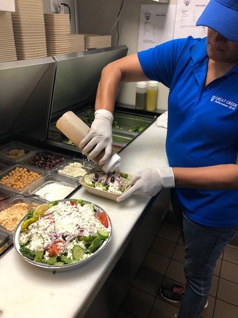 kitchen staff preparing a Greek salad